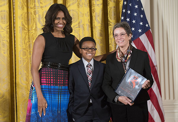 First Lady Michelle Obama presented Project STEP with the National Arts and Humanities Youth Program Award, along with a $10,000 gift, in a ceremony at the White House on Nov. 10. Chosen from a national pool of more than 350 nominations and 50 finalists, STEP is one of 12 programs across the country to receive this prestigious honor. Project STEP Executive Director Mary Jaffee and 11-year-old student Ajani Boyd traveled to the White House to accept the honor in person. Photo: Steven E. Purcell