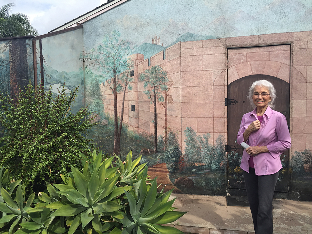 Tiny Todd in the backyard of her and Slim's home in Downey, in front of her proudest painting: a castle wall.
